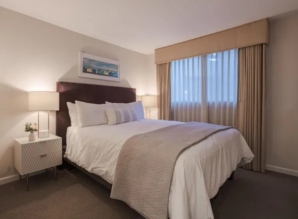 a bedroom with a bed and a night stand