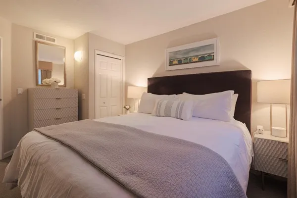 a bedroom with a bed and a painting