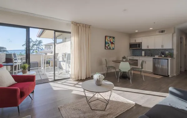 a living room with furniture a rug and a large window