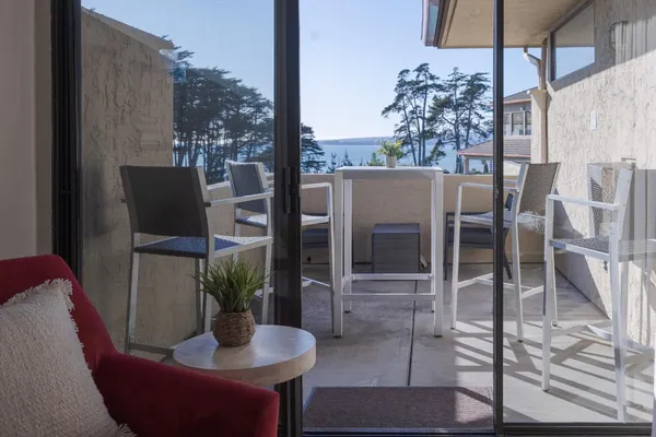 a dining room with furniture and a floor to ceiling window