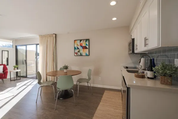 a dining room with furniture and wooden floor