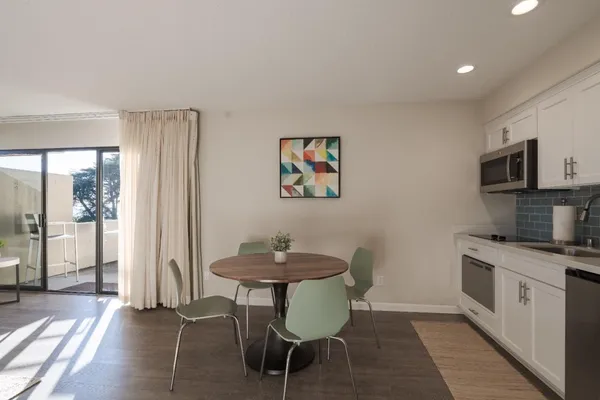 a kitchen with stainless steel appliances kitchen island granite countertop a sink and cabinets
