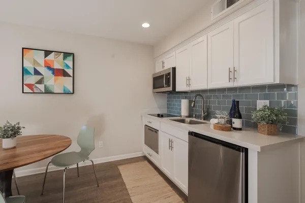 a kitchen with a sink stove and cabinets