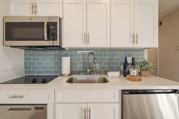 a kitchen with a sink and microwave
