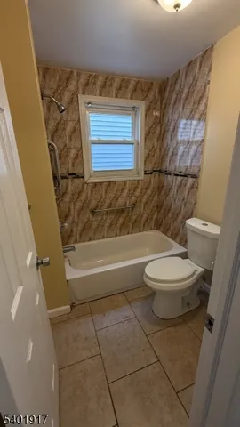 a bathroom with a toilet a sink and bathtub