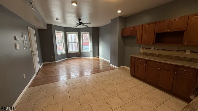 a open kitchen with kitchen island granite countertop a sink window and stainless steel appliances