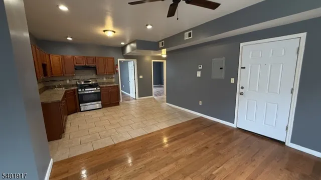 a large kitchen with stainless steel appliances kitchen island a large counter top