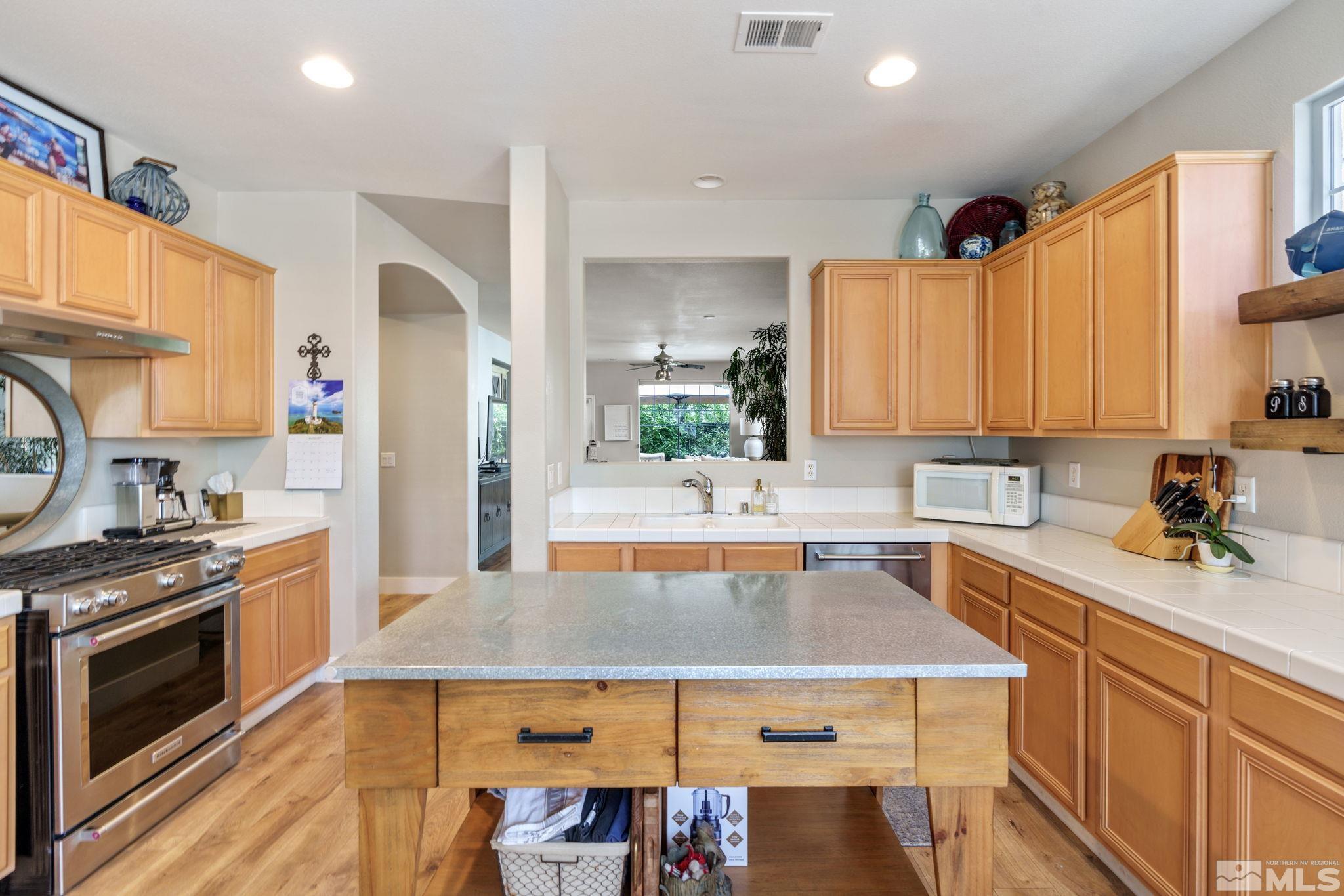 10463 Summershade Lane Reno, NV 89521 - Photo 14 of 33 a kitchen with a table chairs stove and cabinets