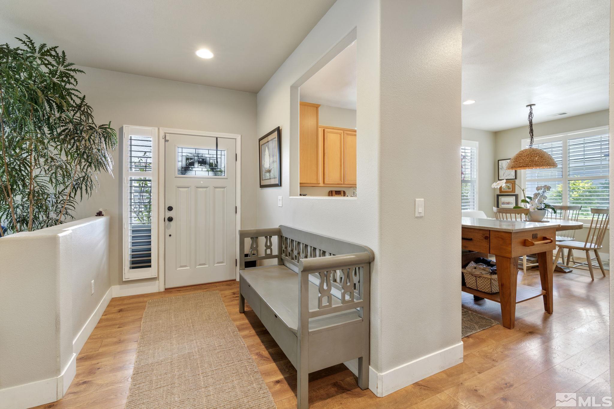 10463 Summershade Lane Reno, NV 89521 - Photo 5 of 33 a spacious bedroom with a bed and a table in it