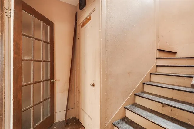 a view of entryway with wooden floor and stairs