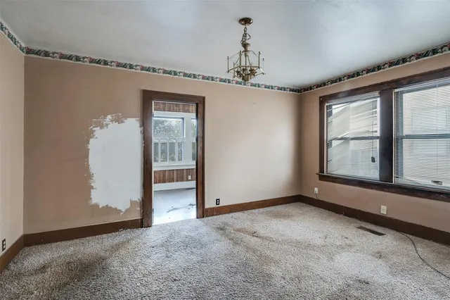 a view of a big room with windows and chandelier