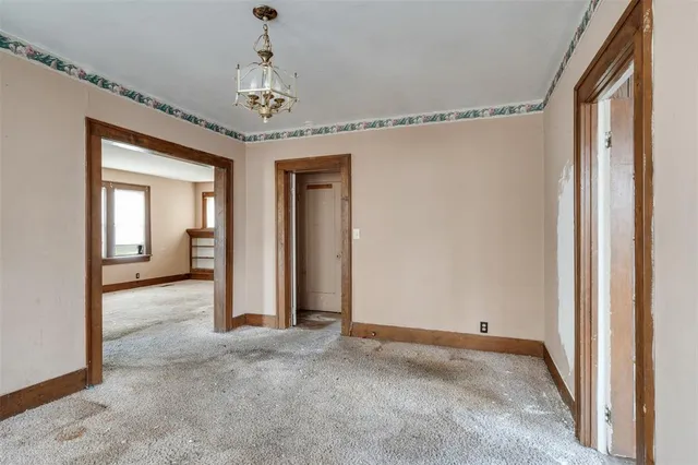 a view of a hallway with windows and stairs