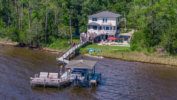 a front view of a house with a yard table and chairs