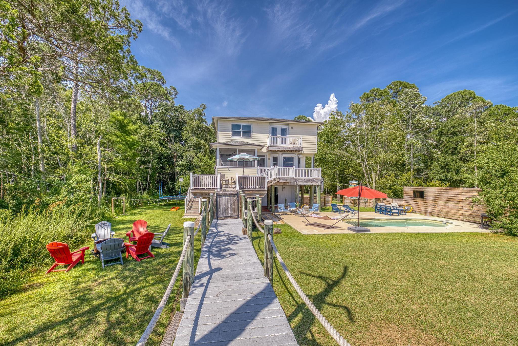 7121 Wells Avenue Navarre, FL 32566 - Photo 101 of 125 a view of a chairs and table on the wooden floor