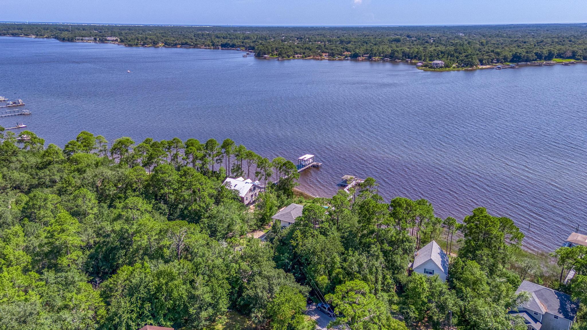 7121 Wells Avenue Navarre, FL 32566 - Photo 108 of 125 an aerial view of a house and lake view