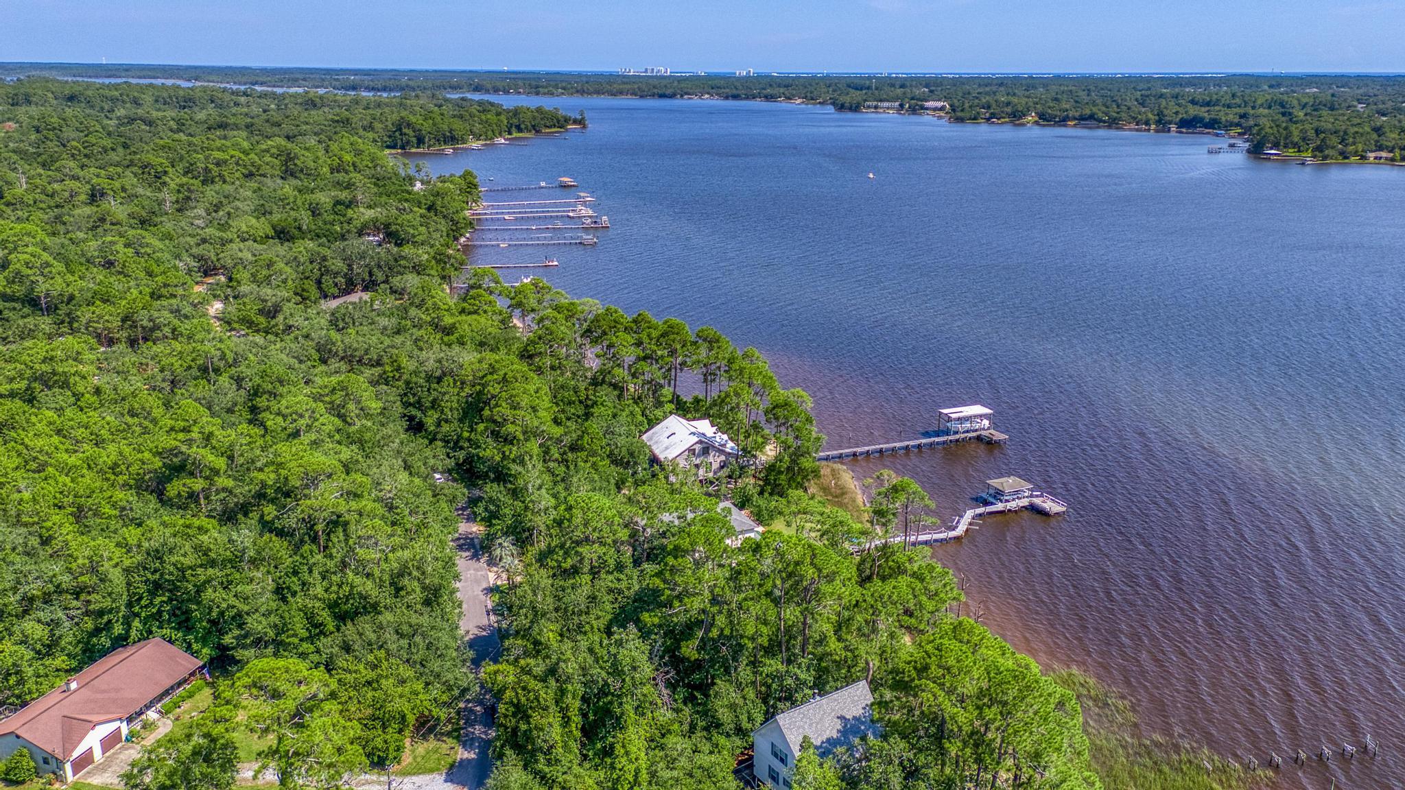 7121 Wells Avenue Navarre, FL 32566 - Photo 109 of 125 an aerial view of a house with a lake view