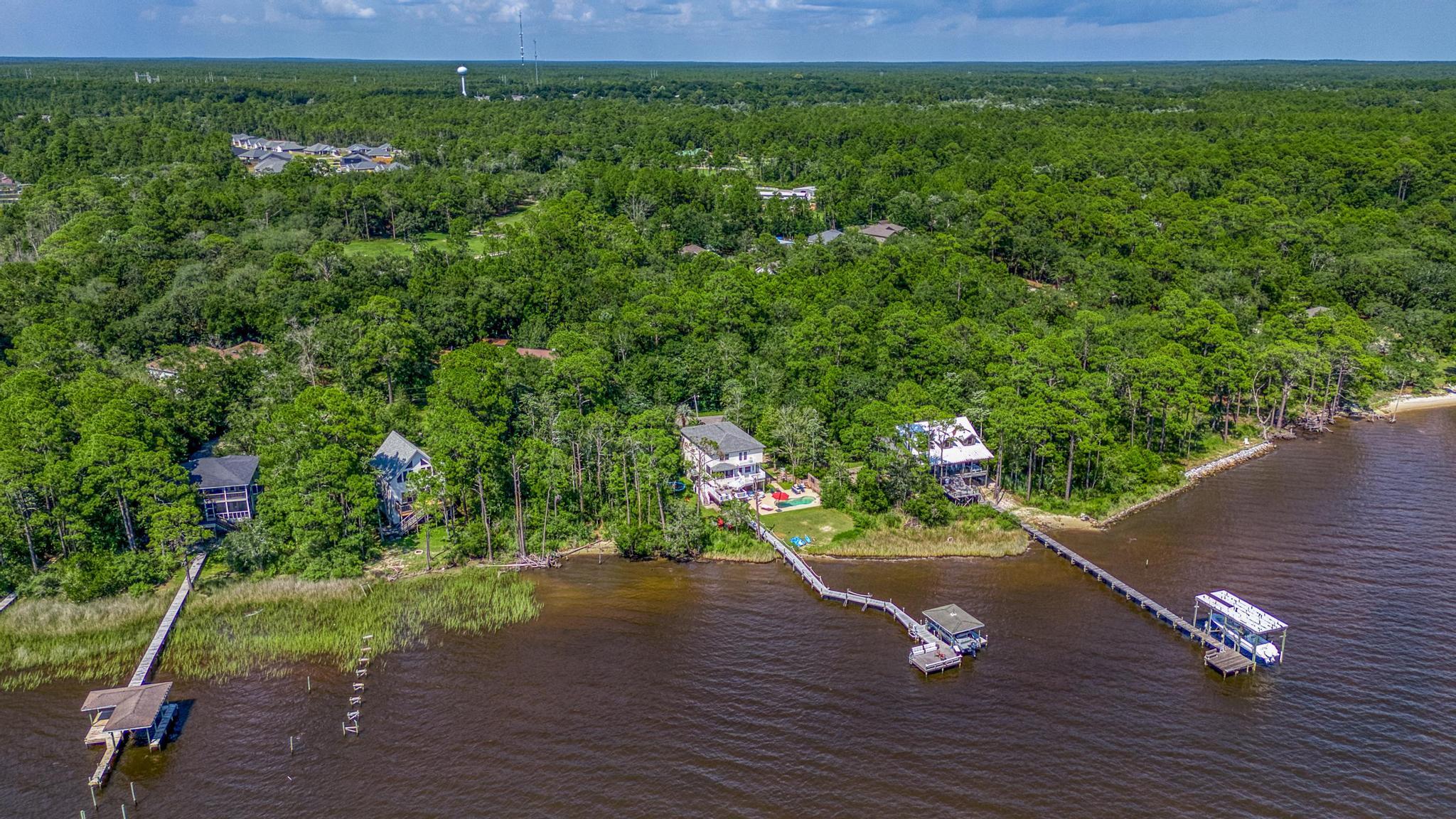 7121 Wells Avenue Navarre, FL 32566 - Photo 112 of 125 a view of a wooden deck with a yard