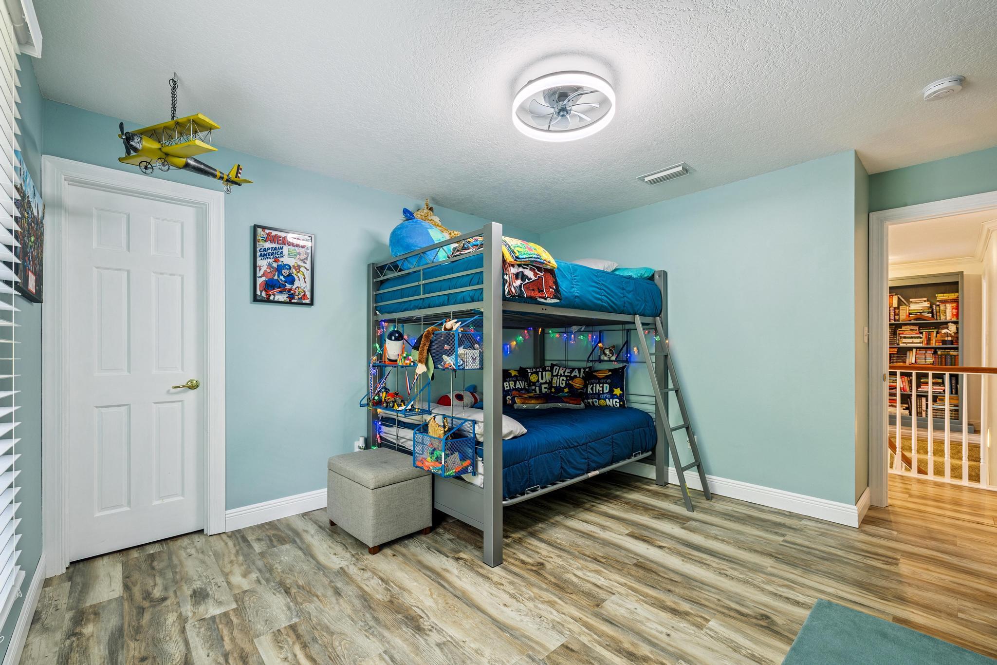 7121 Wells Avenue Navarre, FL 32566 - Photo 12 of 125 a bedroom with a bed and wooden floor