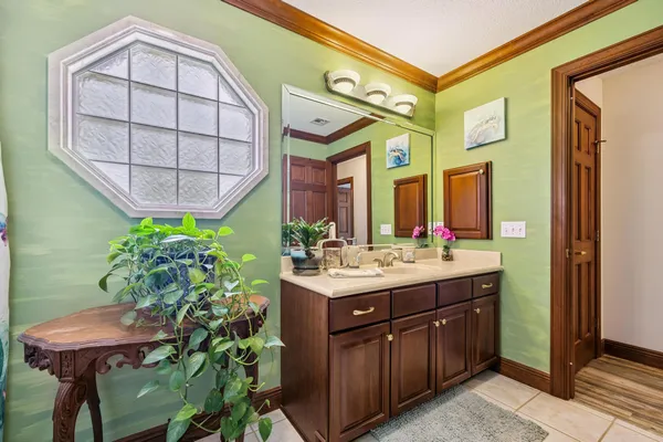 a kitchen with a sink a counter top space stainless steel appliances and a large window
