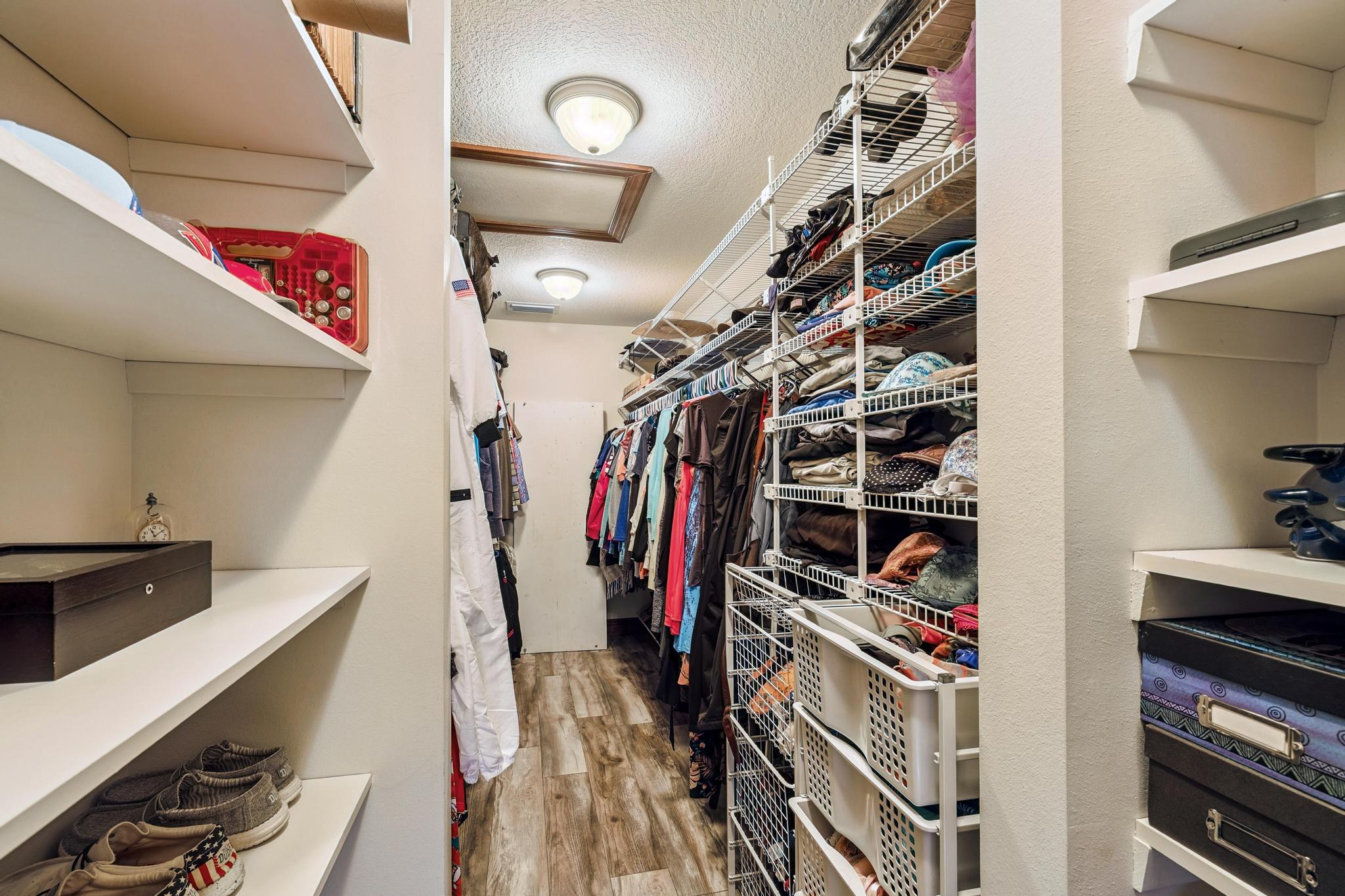 7121 Wells Avenue Navarre, FL 32566 - Photo 23 of 125 a view of walk in closet with clothes and shoes