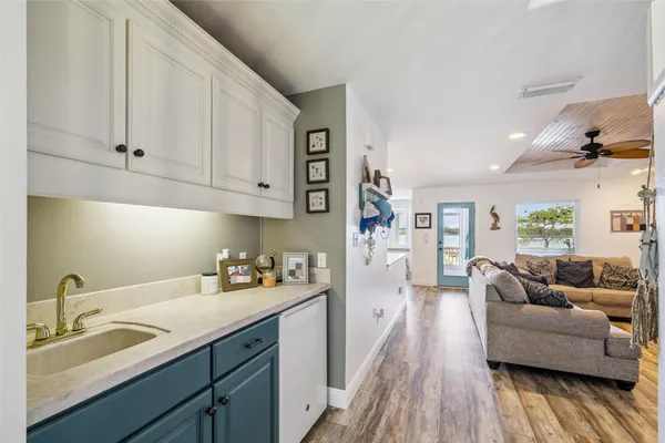 a view of a roof deck with table and chairs under an umbrella with wooden floor