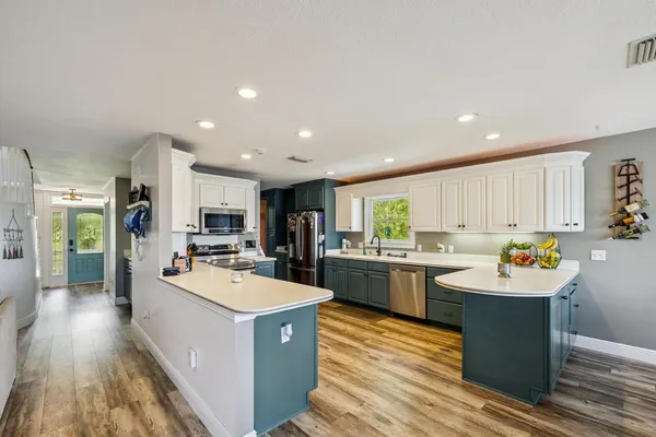 a view of a patio with a table and chairs under an umbrella
