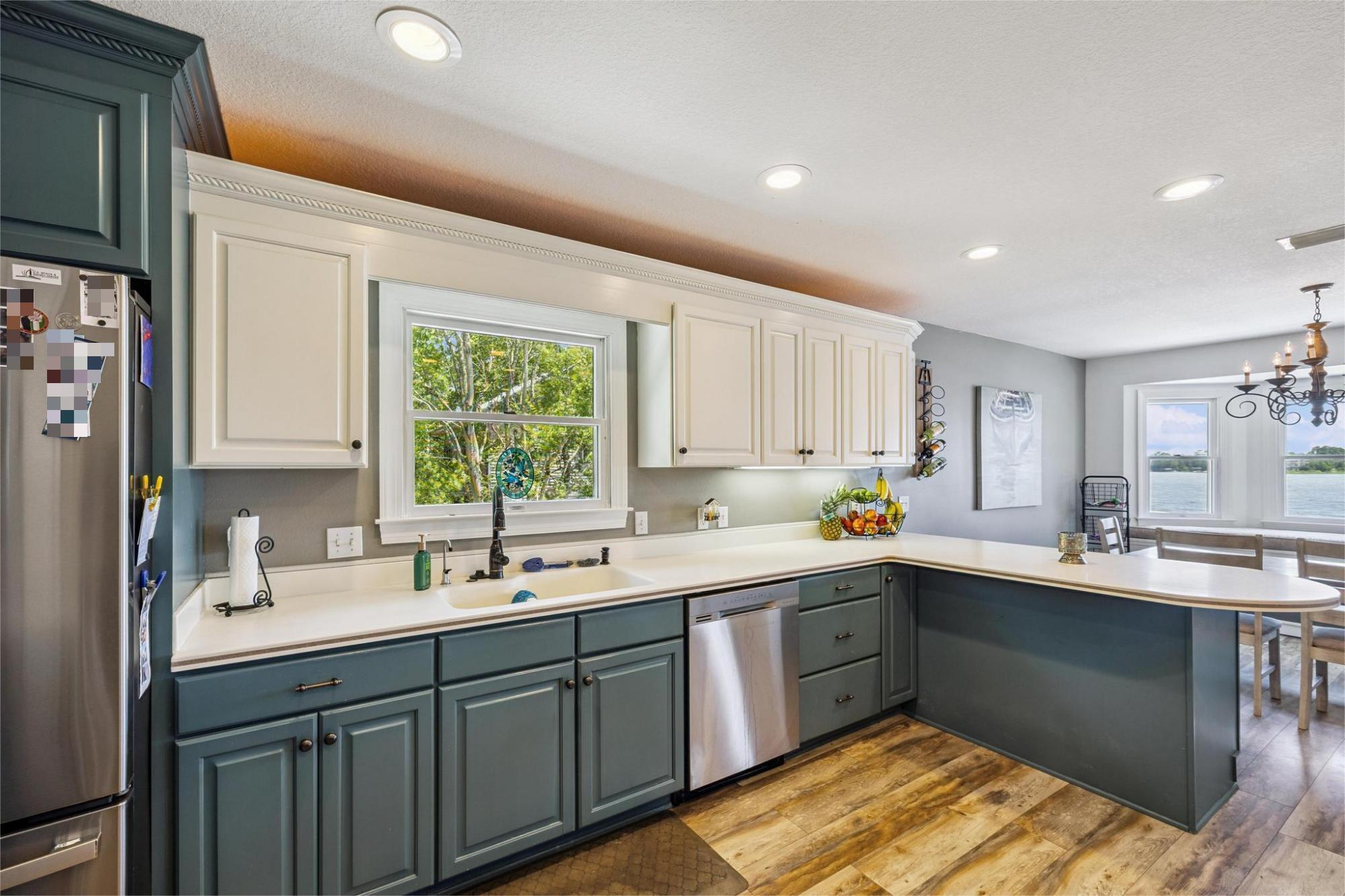 7121 Wells Avenue Navarre, FL 32566 - Photo 39 of 125 a kitchen with a sink stove and cabinets