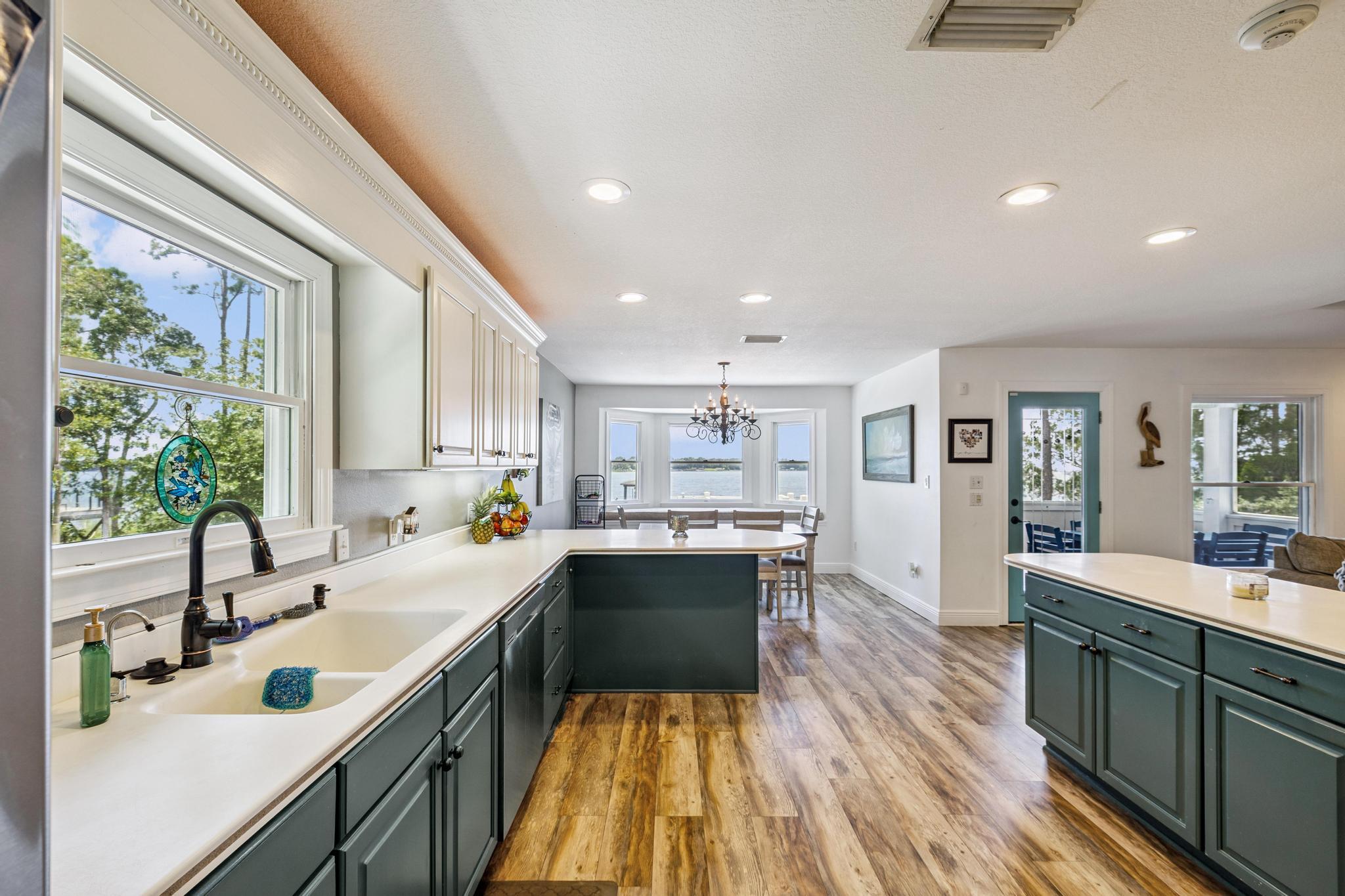 7121 Wells Avenue Navarre, FL 32566 - Photo 40 of 125 a kitchen with a sink a counter top space stainless steel appliances and a large window