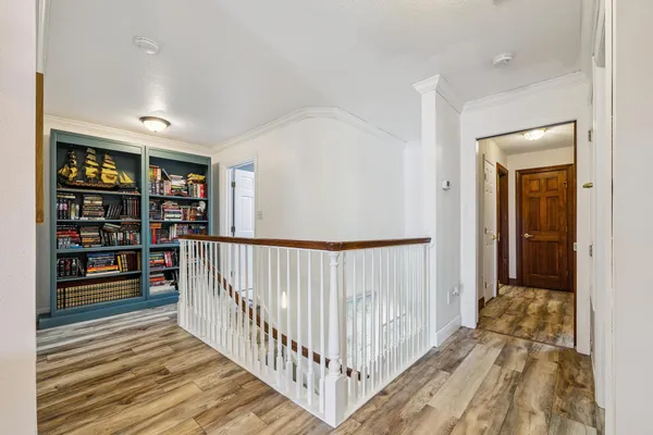 a bedroom with a bed and a flat tv screen on dresser