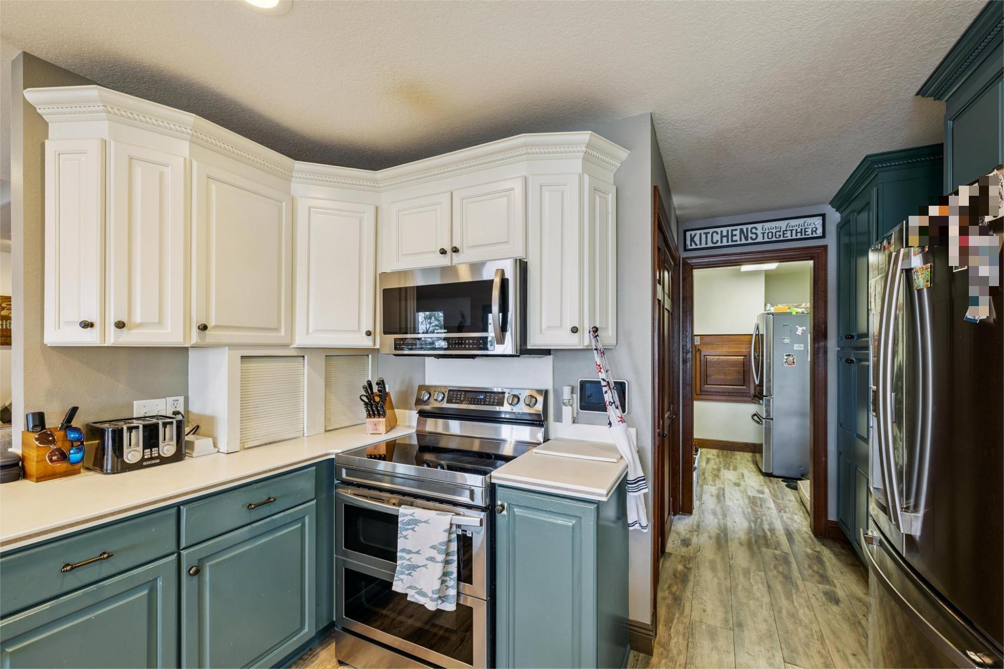 7121 Wells Avenue Navarre, FL 32566 - Photo 42 of 125 a kitchen with stainless steel appliances granite countertop a stove a sink and a refrigerator