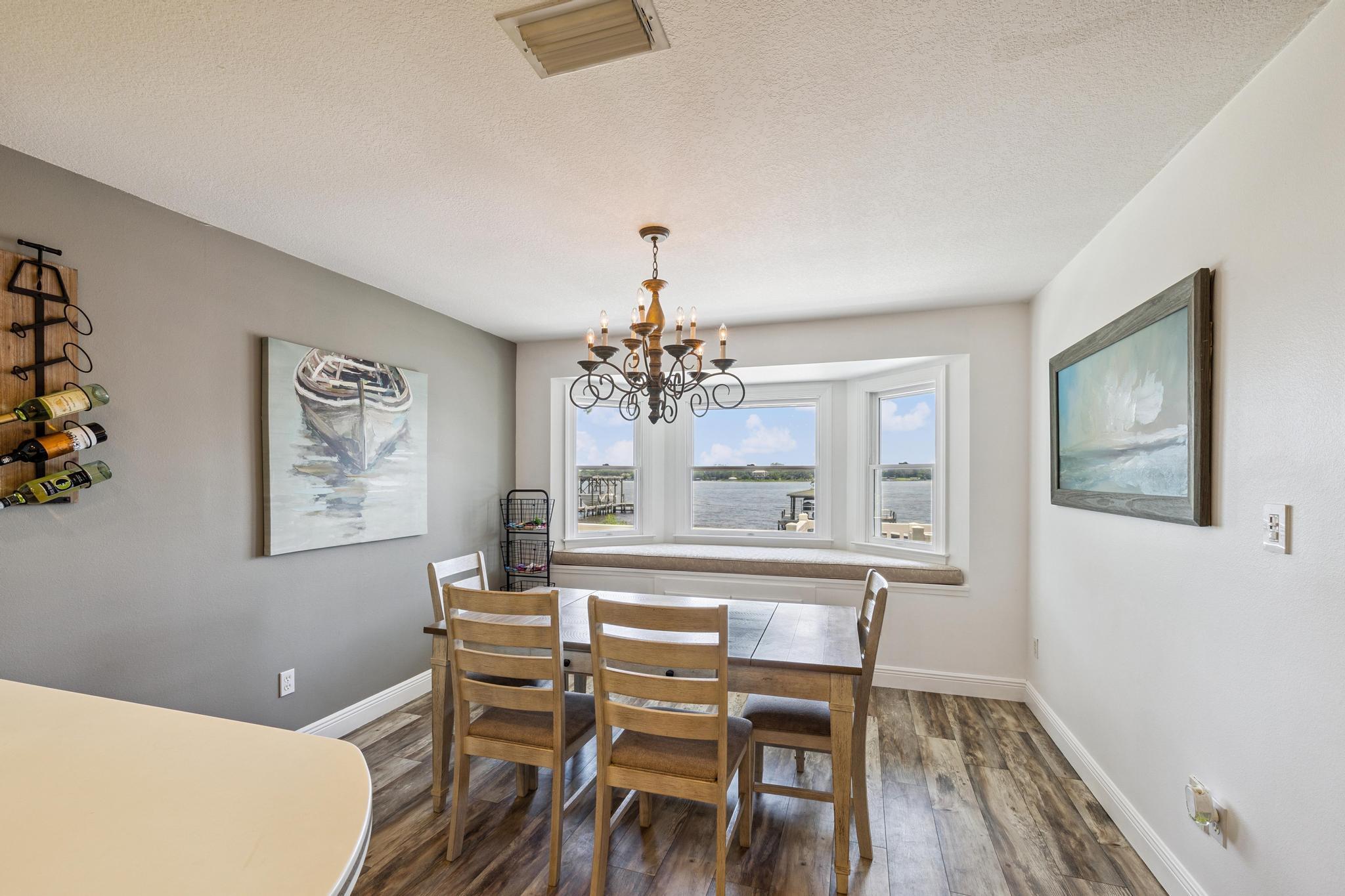 7121 Wells Avenue Navarre, FL 32566 - Photo 43 of 125 a view of a dining room with furniture wooden floor and a chandelier