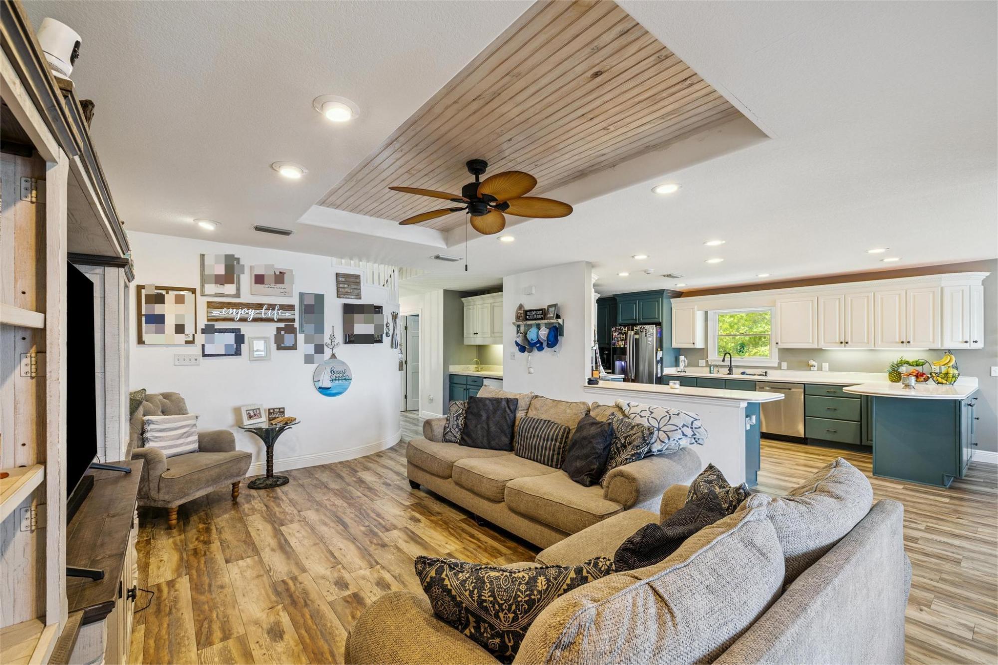 7121 Wells Avenue Navarre, FL 32566 - Photo 49 of 125 a living room with furniture kitchen view and a chandelier