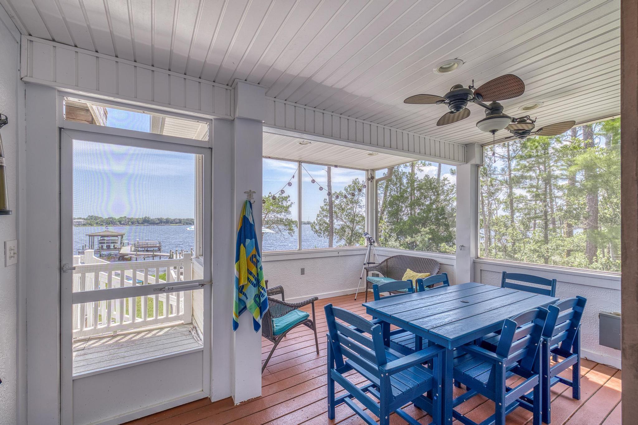 7121 Wells Avenue Navarre, FL 32566 - Photo 50 of 125 a view of a dining room with furniture large windows and wooden floor