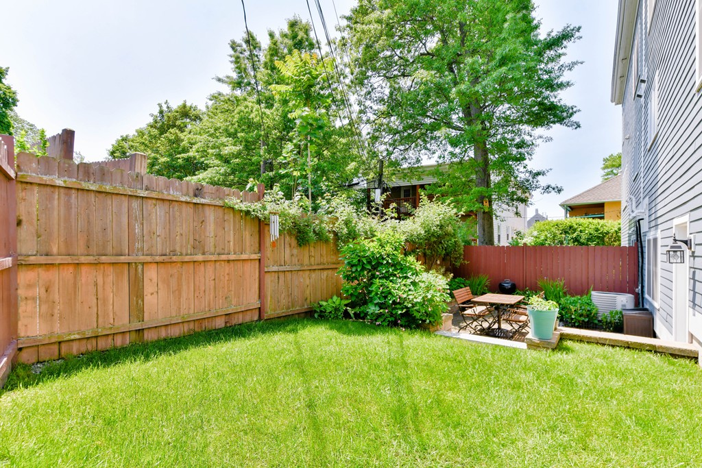 2 Mendell Way, Unit 2 Boston, MA 02130 - Photo 11 of 12 a view of a backyard with potted plants and large tree