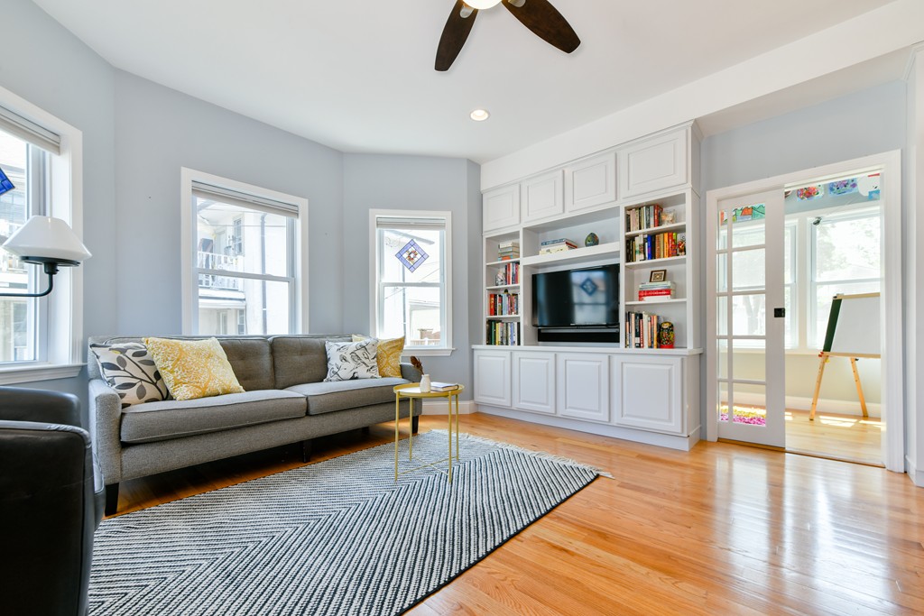 2 Mendell Way, Unit 2 Boston, MA 02130 - Photo 2 of 12 a living room with furniture and a flat screen tv