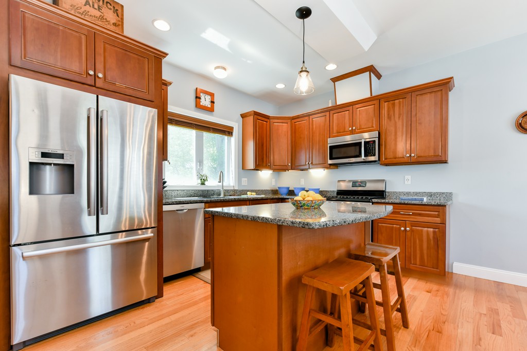 2 Mendell Way, Unit 2 Boston, MA 02130 - Photo 4 of 12 a kitchen with stainless steel appliances granite countertop a refrigerator a stove top oven a sink dishwasher and a refrigerator with wooden floor