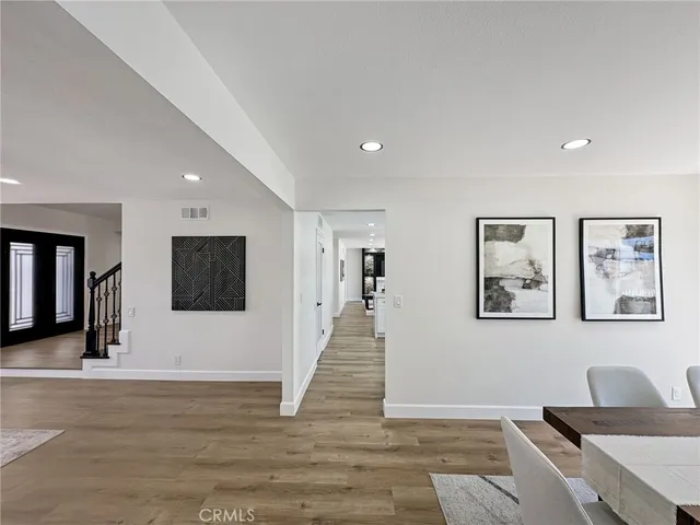 a hallway with wooden floor and furniture