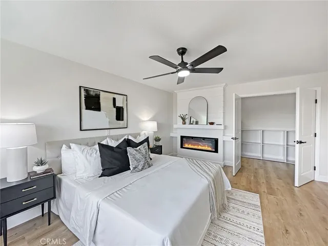 a bedroom with a large bed and a fireplace