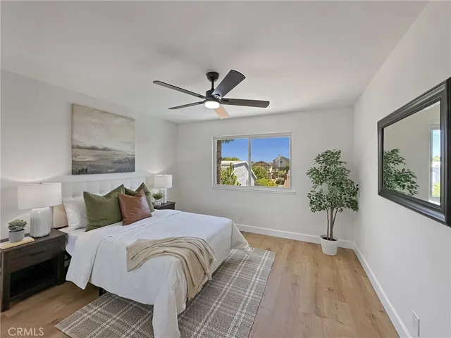 a bedroom with a large bed and a chandelier