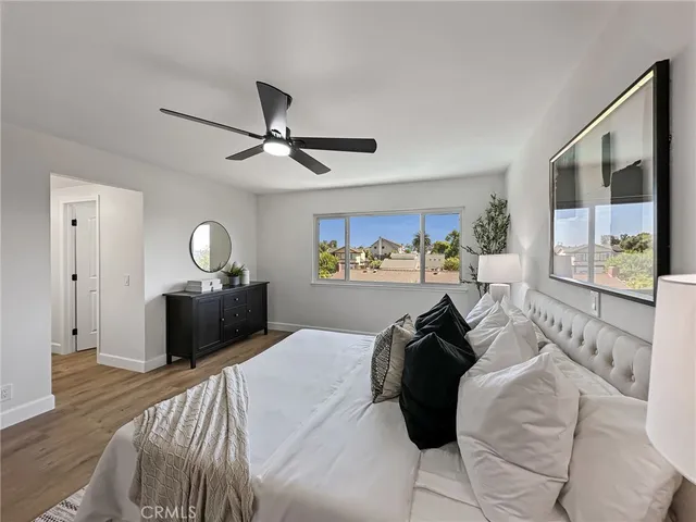 a bedroom with a bed and wooden floor