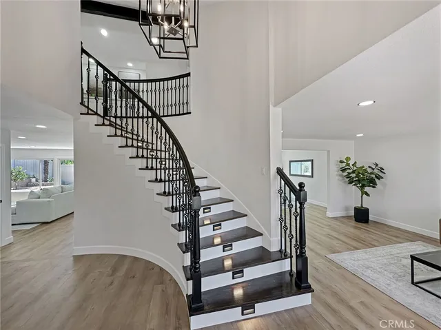 a view of entryway and hall with wooden floor
