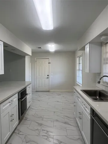 a kitchen with a sink and cabinets