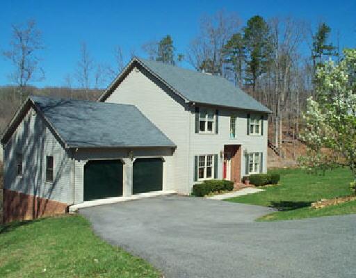 159 Oak Ridge Court Blue Ridge, VA 24064 - Photo 1 of 2 a front view of a house with a garden and plants