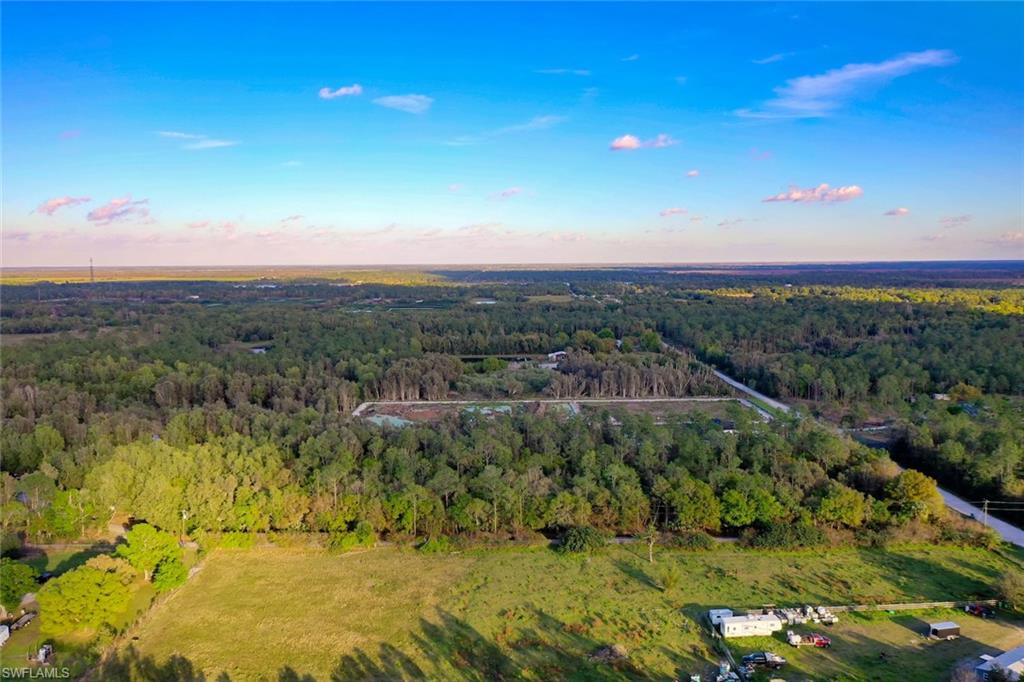 0 Platt Road Naples, FL 34120 - Photo 12 of 16 Aerial view of property and surrounding area with a heavily wooded area