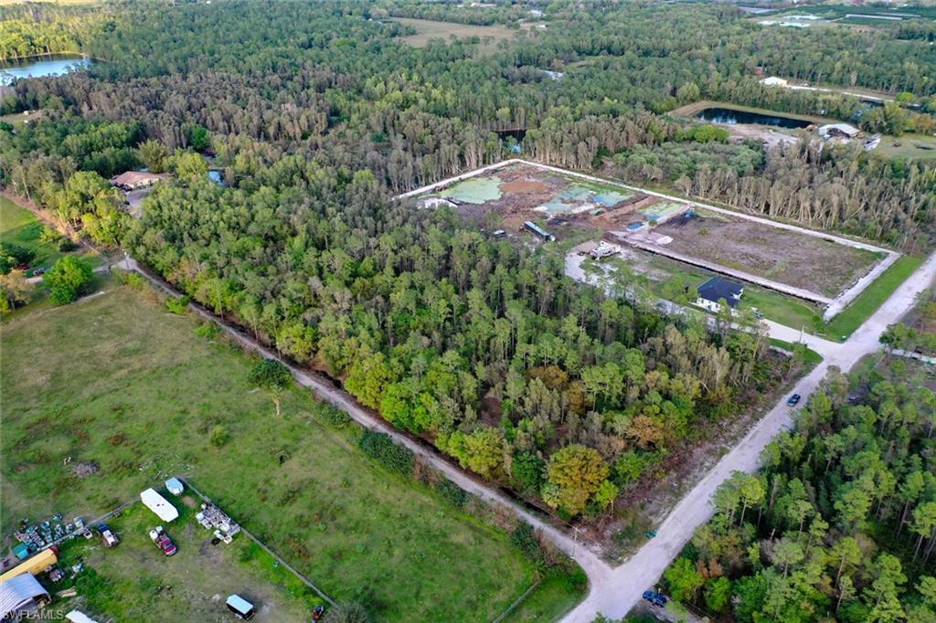 0 Platt Road Naples, FL 34120 - Photo 2 of 16 Aerial view of property and surrounding area featuring a forest and property boundaries highlighted