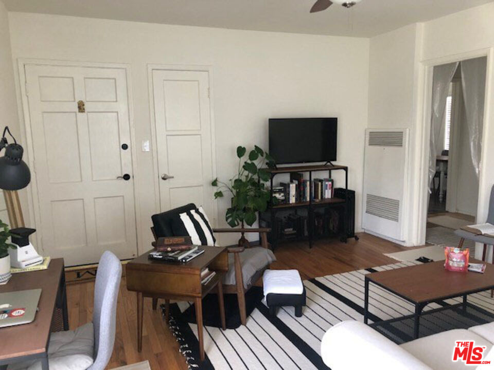 4114 Warner Boulevard Burbank, CA 91505 - Photo 9 of 15 a living room with furniture a flat screen tv and a table
