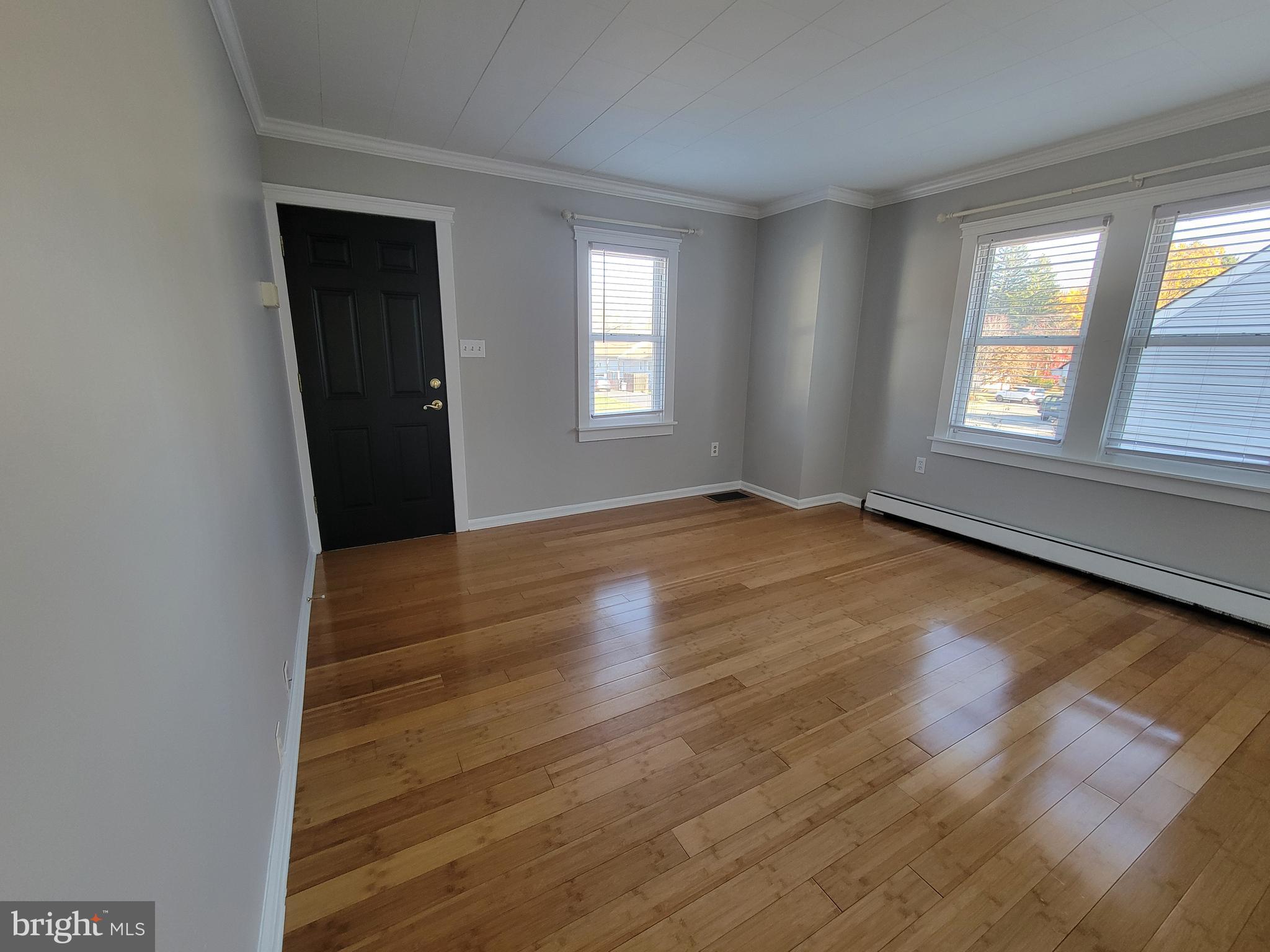11 Zieglers Lane Hamilton, NJ 08690 - Photo 3 of 20 an empty room with wooden floor and windows