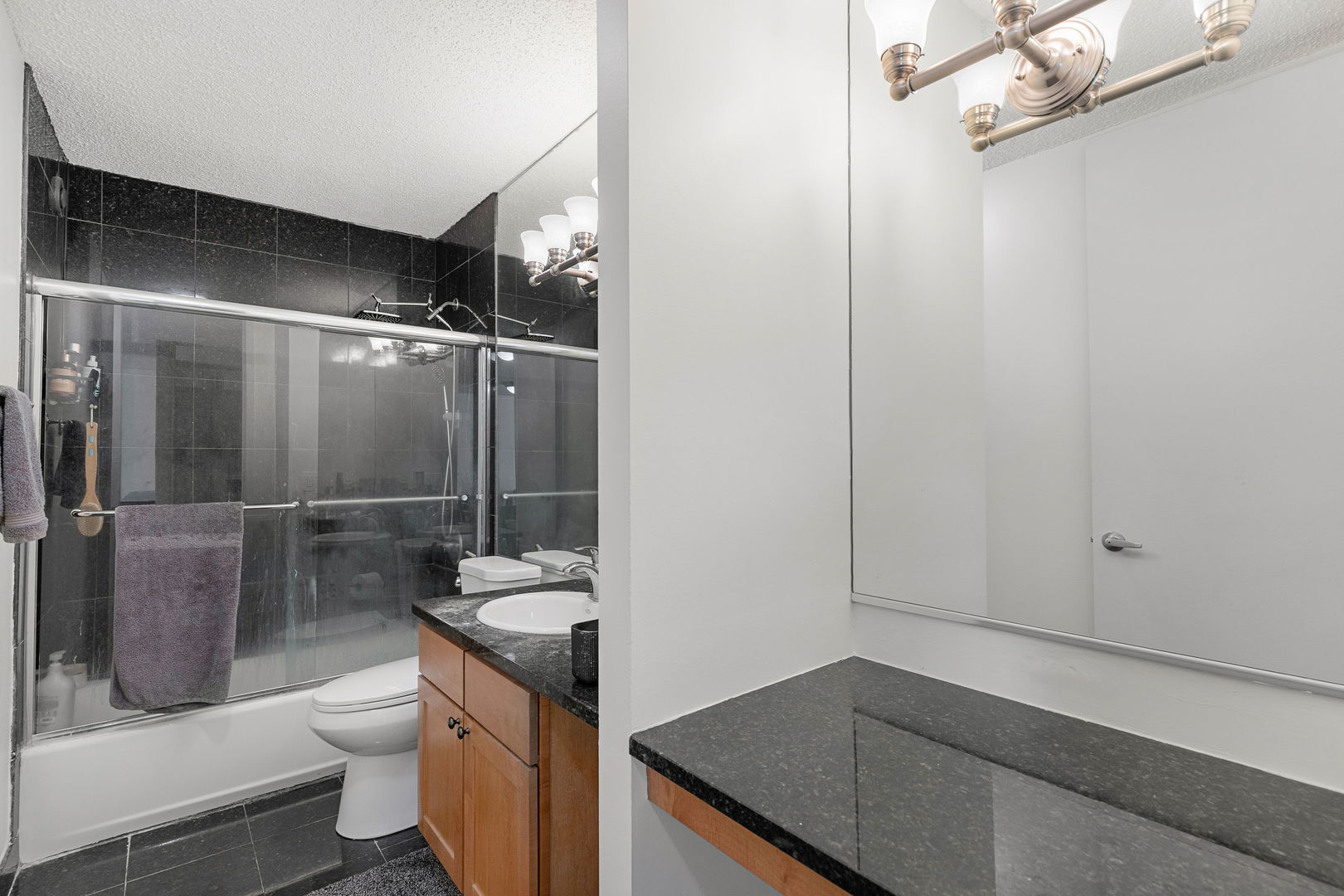 30 East Huron Street, Unit 3410 Chicago, IL 60611 - Photo 11 of 16 a bathroom with a granite countertop sink toilet and shower