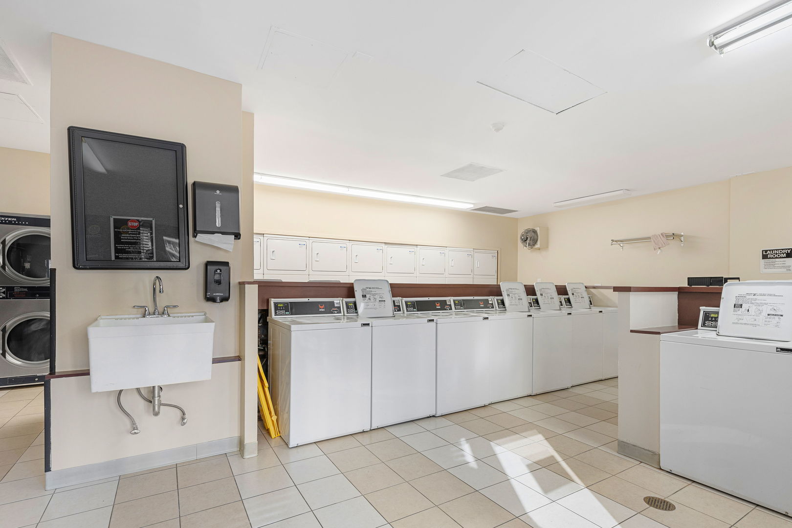 30 East Huron Street, Unit 3410 Chicago, IL 60611 - Photo 14 of 16 a kitchen with a refrigerator and white cabinets