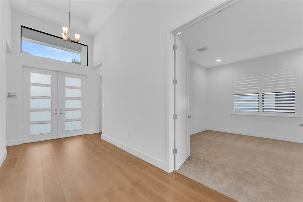 20041 Pacific Dunes Drive Boca Raton, FL 33434 - Photo 8 of 64 a view of an empty room with a window and wooden floor